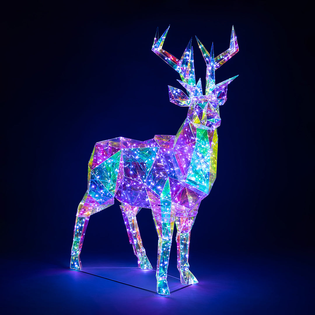 Christow Large Iridescent Christmas Stag Light with shimmering rainbow-effect panels and white LEDs glowing against a dark background