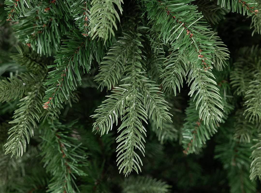 Close-up of realistic PE Fraser Fir branch tips on the Christow Pre-Lit 10ft Artificial Christmas Tree showing natural two-tone green needle detail