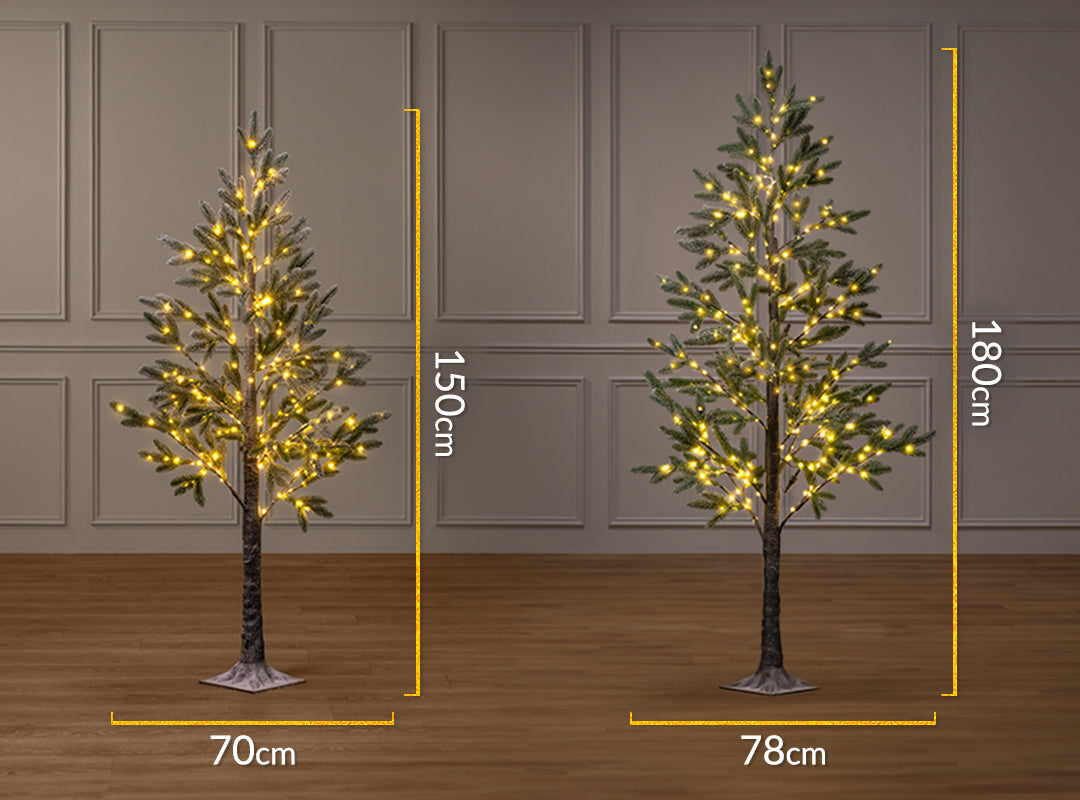 Size comparison of Christow Pre-Lit Halden Fir Flocked Artificial Christmas Trees in 5ft (150cm) and 6ft (180cm) heights, with widths of 70cm and 78cm respectively