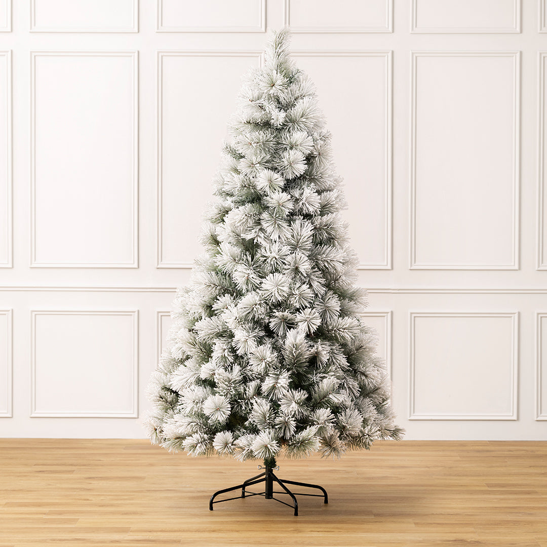 Christow Valmorel Flocked Artificial Christmas Tree with a full, tapered shape and heavily snow-flocked green branches
