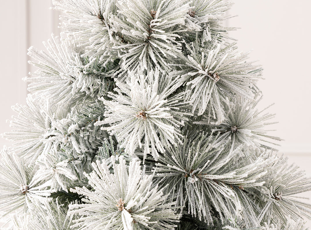 Close-up of realistic pine needles and classic PVC tips with heavy snow flocking on the Christow Valmorel Flocked Artificial Christmas Tree