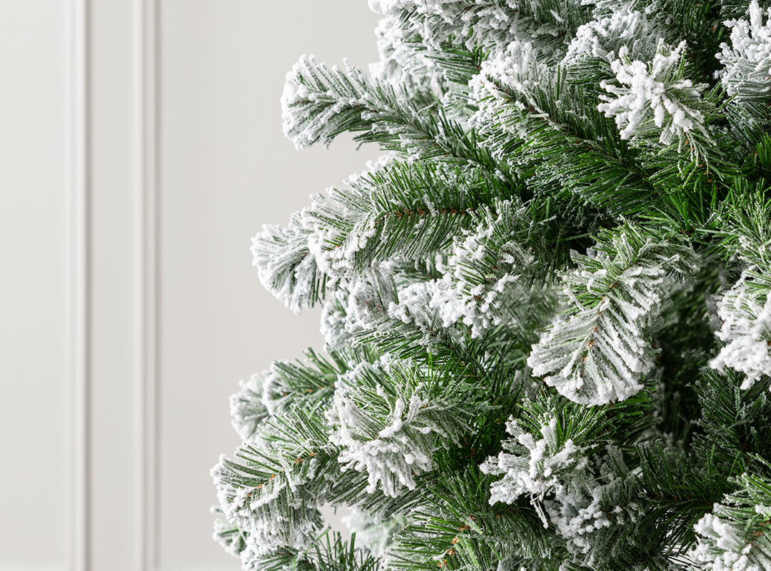 Close-up of dual-toned green PVC tips with snow flocking on the Christow Chamonix Spruce Flocked Artificial Christmas Tree