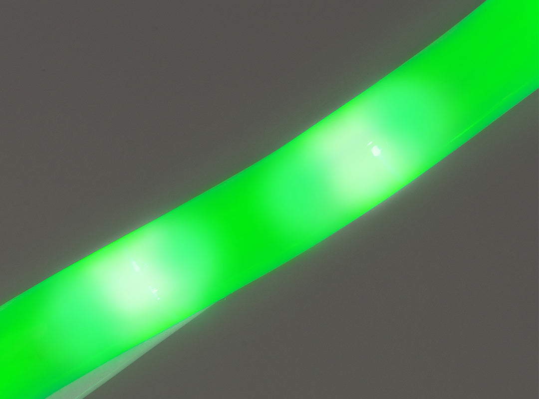Close-up of milk-coloured rope light tubing on the Christow Christmas Tree Rope Light Silhouette, showing bright green LEDs glowing from within the tubing against a grey background