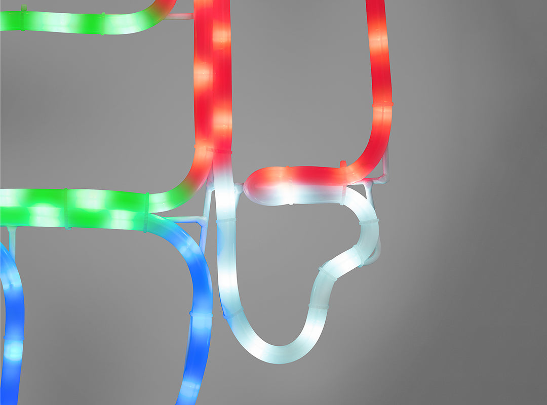 Close-up of milk-coloured rope light tubing on the Christow Nutcracker Christmas Rope Light, showing red, green, blue, and cool white LEDs glowing brightly from within the tubing against a grey background