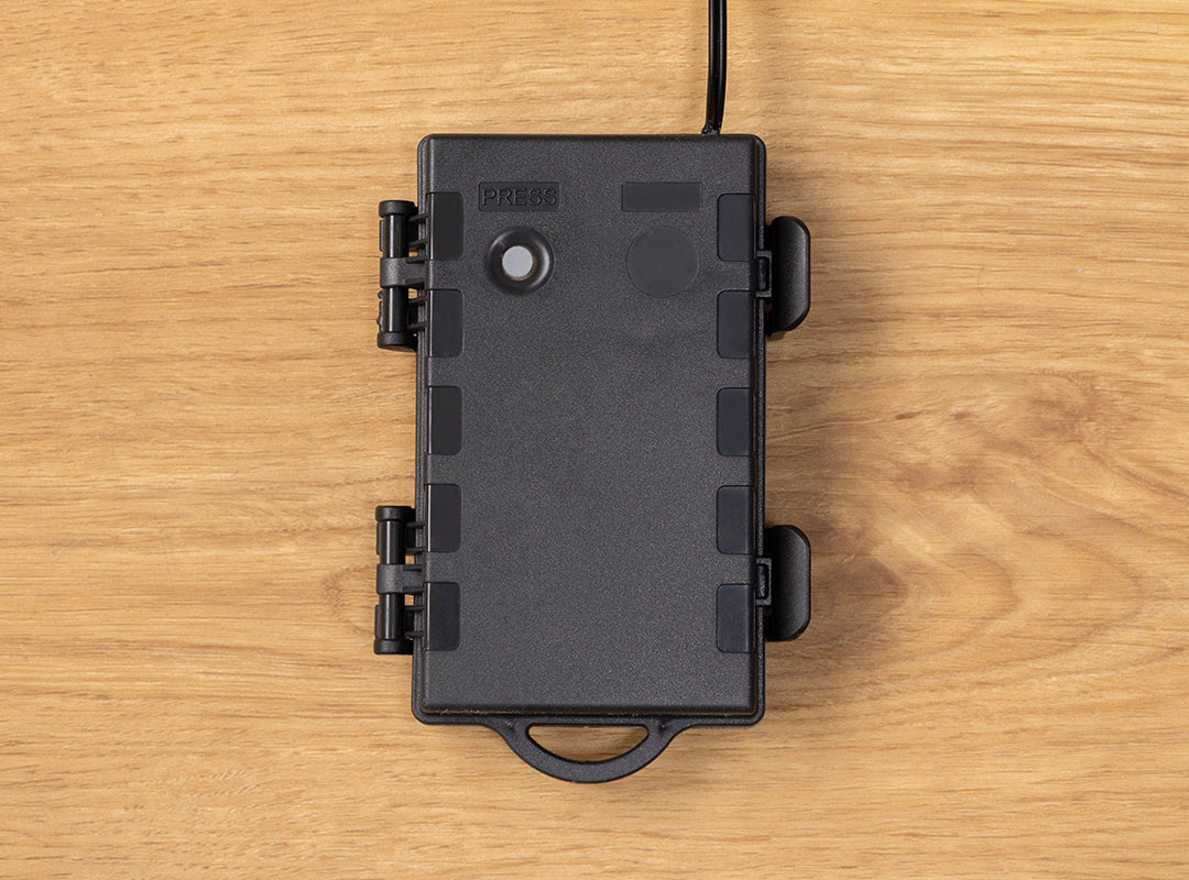 Close-up of the IP44-rated battery box with timer button on the Christow Battery-Powered LED Maypole Christmas Tree